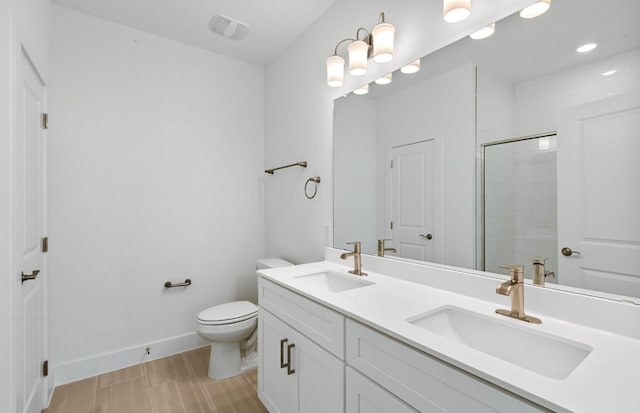 585 Tailwind Dr, Kyle, TX 78640 - full bathroom with toilet, a shower with shower door, double vanity, and baseboards