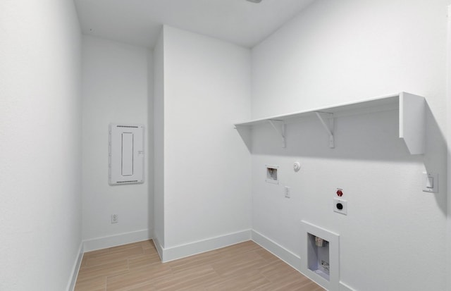 585 Tailwind Dr, Kyle, TX 78640 - clothes washing area with hookup for a gas dryer, electric dryer hookup, light wood-style floors, baseboards, and washer hookup
