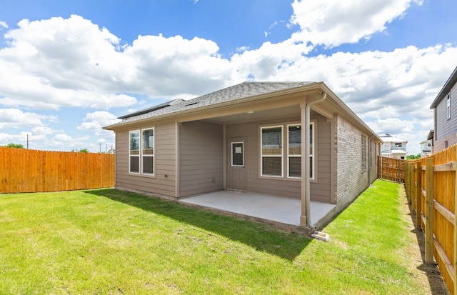 585 Tailwind Dr, Kyle, TX 78640 - back of property featuring a patio and roof with shingles