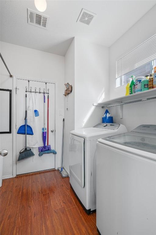 laundry area featuring independent washer and dryer, laundry area, wood finished floors, and visible vents
