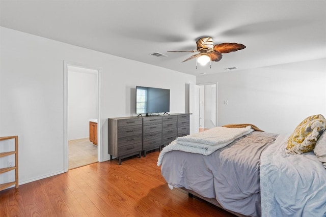 bedroom featuring light wood-style floors, ceiling fan, and visible vents