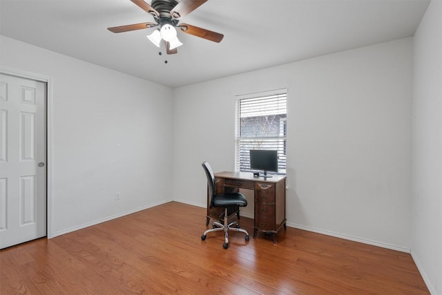 home office featuring ceiling fan, wood finished floors, and baseboards