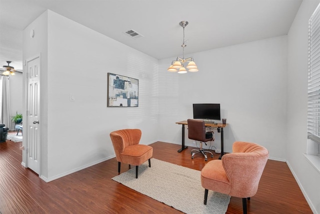 office featuring visible vents, baseboards, ceiling fan with notable chandelier, and wood finished floors