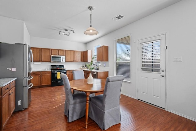 dining space with visible vents and dark wood-style floors