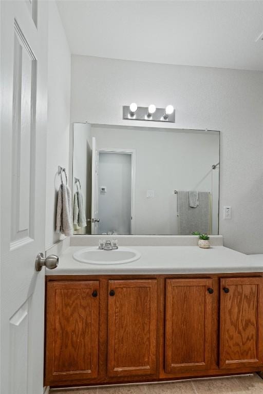 bathroom with walk in shower and vanity