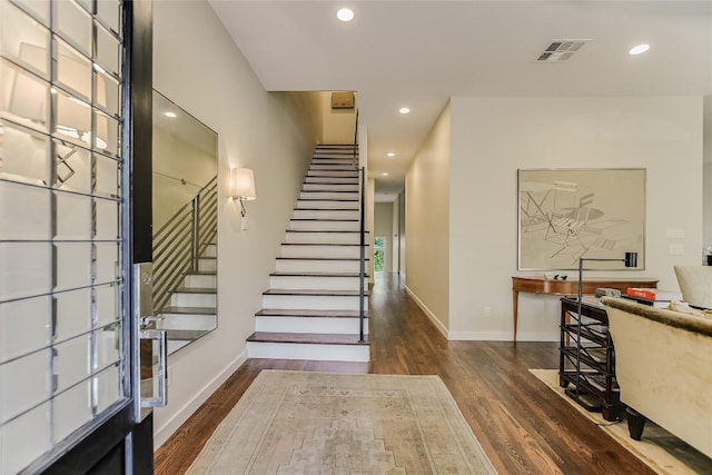 entryway with recessed lighting, baseboards, wood finished floors, and stairs