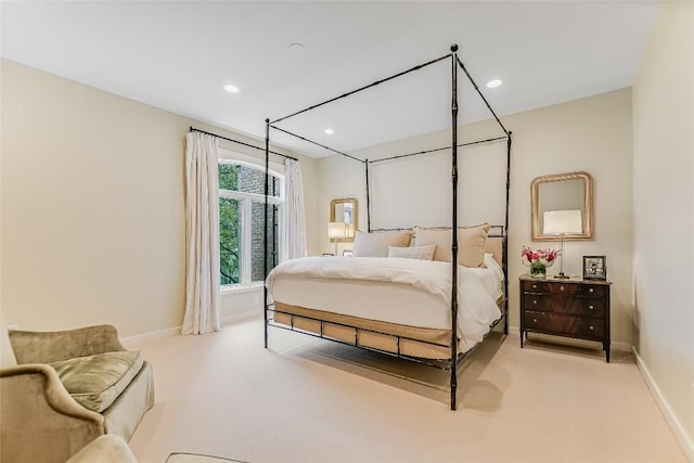 bedroom with recessed lighting, baseboards, and light carpet