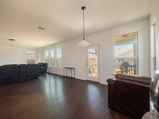 670 Landon Samuel Loop, Pflugerville, TX 78660 - living area featuring dark wood-style flooring and baseboards