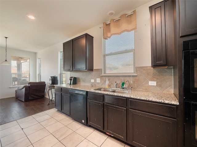 670 Landon Samuel Loop, Pflugerville, TX 78660 - kitchen with black appliances, plenty of natural light, and dark brown cabinets