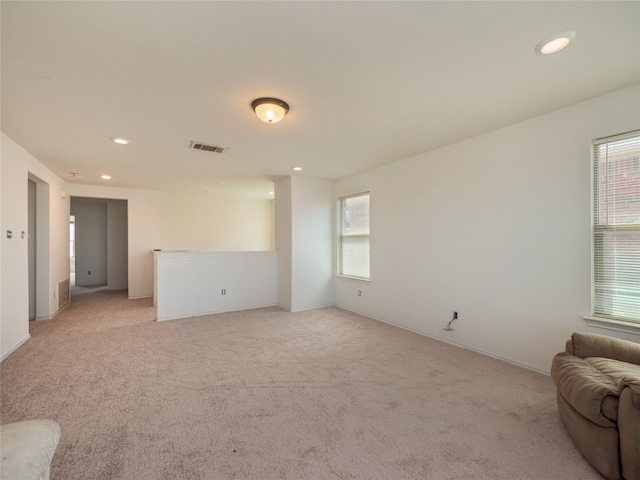 670 Landon Samuel Loop, Pflugerville, TX 78660 - unfurnished living room with healthy amount of natural light, recessed lighting, and light carpet