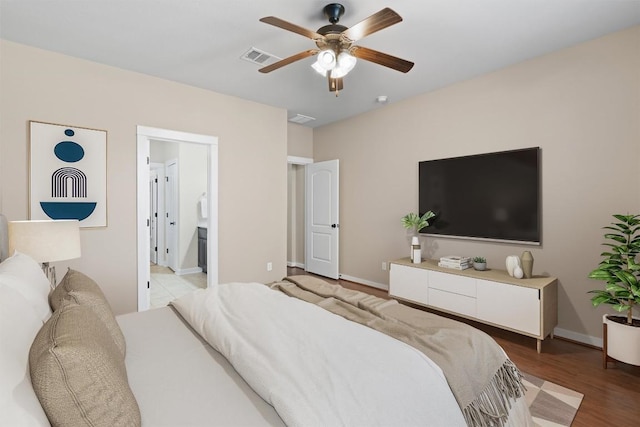 4706 Madrid Dr, Georgetown, TX 78628 - bedroom featuring light wood-style flooring, baseboards, a ceiling fan, and connected bathroom