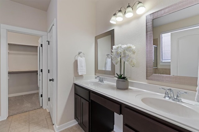 4706 Madrid Dr, Georgetown, TX 78628 - bathroom with double vanity, a spacious closet, tile patterned floors, and a shower