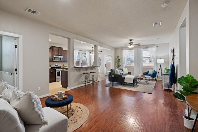 4706 Madrid Dr, Georgetown, TX 78628 - living area with ceiling fan, wood finished floors, and baseboards