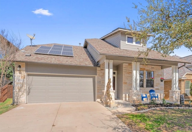4706 Madrid Dr, Georgetown, TX 78628 - view of front of property featuring a porch, roof mounted solar panels, concrete driveway, and stone siding
