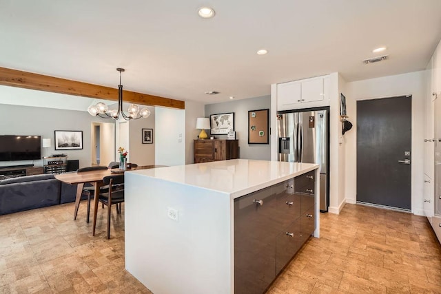 kitchen featuring visible vents, decorative light fixtures, white cabinetry, recessed lighting, and stainless steel fridge