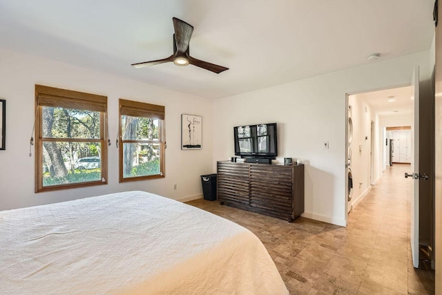 bedroom featuring a ceiling fan and baseboards