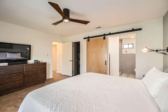 bedroom featuring a barn door, baseboards, visible vents, and a ceiling fan