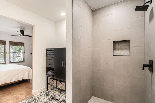 bathroom featuring a ceiling fan, baseboards, a tile shower, and connected bathroom