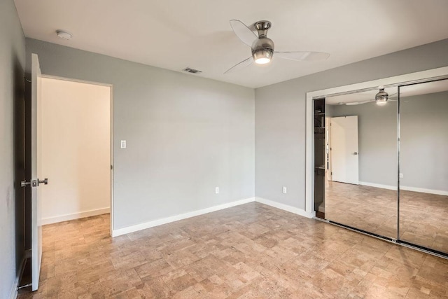 unfurnished bedroom with a ceiling fan, visible vents, baseboards, and a closet