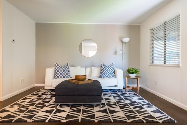 living area with baseboards and wood finished floors