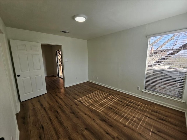6903 Deatonhill Dr Unit 2, Austin, TX 78745 - unfurnished bedroom featuring dark wood-type flooring and baseboards