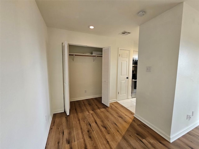 6903 Deatonhill Dr Unit 2, Austin, TX 78745 - unfurnished bedroom with wood finished floors, a closet, and recessed lighting