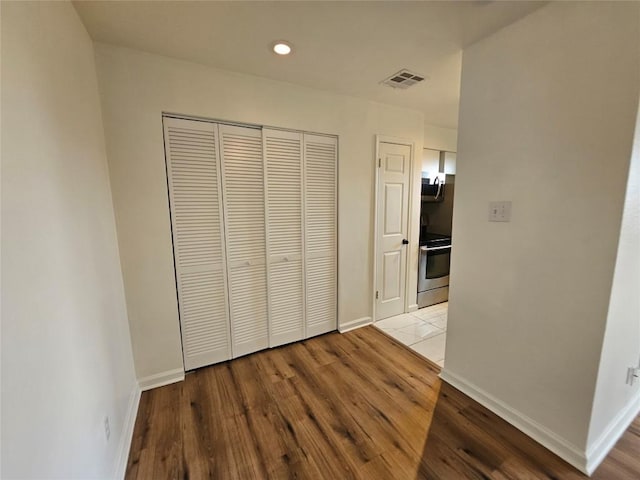 6903 Deatonhill Dr Unit 2, Austin, TX 78745 - unfurnished bedroom with wood finished floors, a closet, and recessed lighting