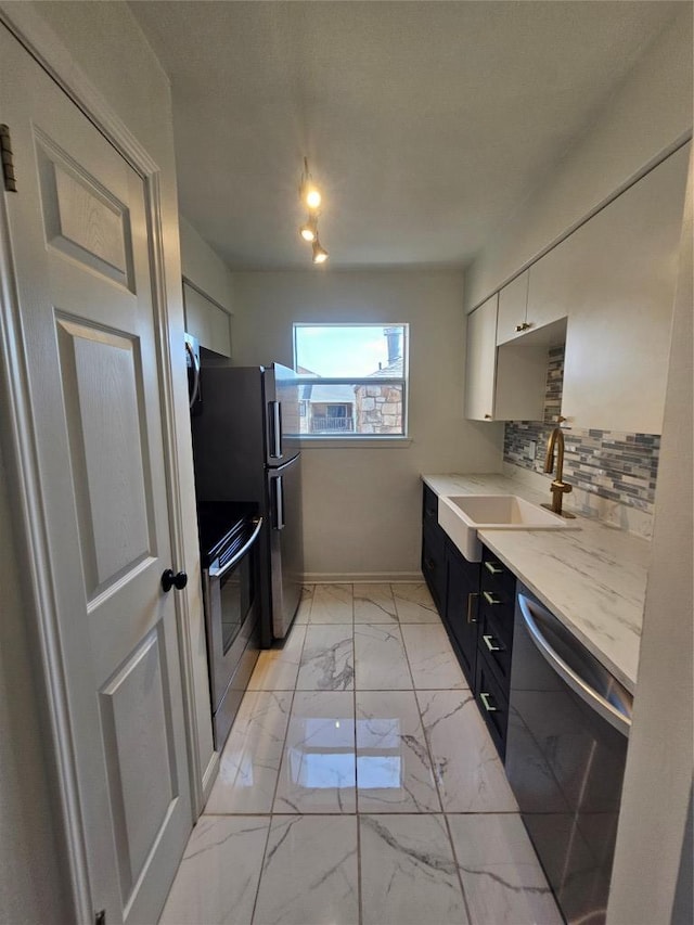 6903 Deatonhill Dr Unit 2, Austin, TX 78745 - kitchen featuring stainless steel appliances, light countertops, light marble finish floors, decorative backsplash, and white cabinetry