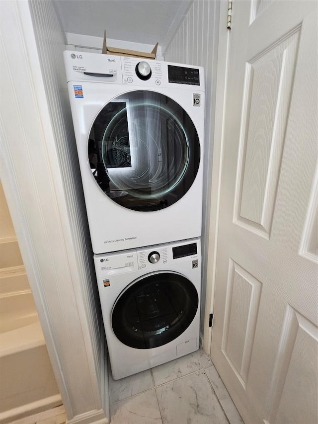 6903 Deatonhill Dr Unit 2, Austin, TX 78745 - laundry room featuring stacked washing machine and dryer and light marble finish flooring