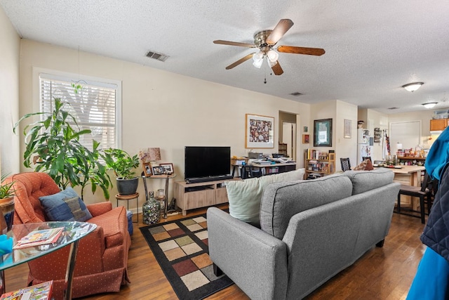 1513 Ruth Ave, Austin, TX 78757 - living area featuring ceiling fan, visible vents, a textured ceiling, and wood finished floors