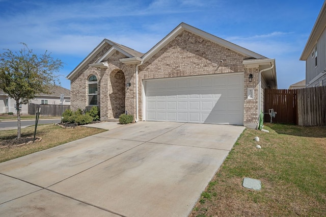 6300 Mary Lewis Dr, Austin, TX 78747 - view of front of house with concrete driveway, a garage, and brick siding