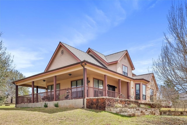 149 Colovista Dr, Bastrop, TX 78602 - view of property exterior featuring a metal roof, covered porch, and a yard