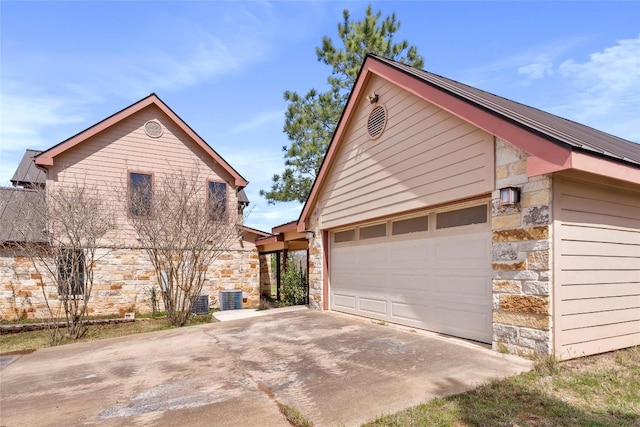 149 Colovista Dr, Bastrop, TX 78602 - view of property exterior featuring stone siding, concrete driveway, and an attached garage