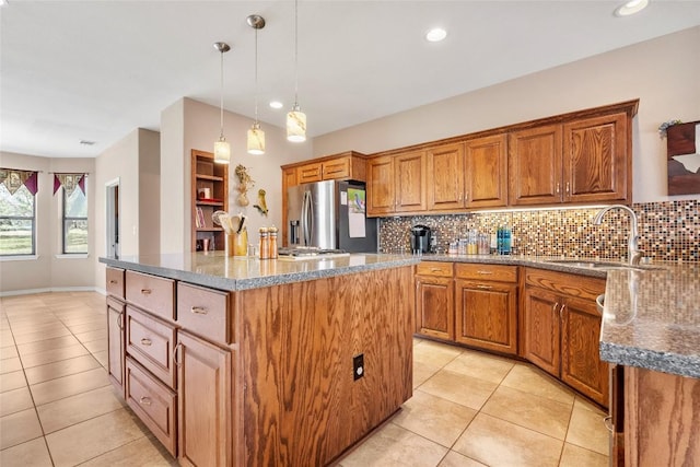 149 Colovista Dr, Bastrop, TX 78602 - kitchen featuring stainless steel fridge with ice dispenser, a kitchen island, light tile patterned floors, backsplash, and recessed lighting