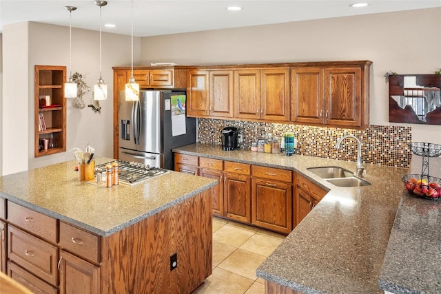 149 Colovista Dr, Bastrop, TX 78602 - kitchen featuring stainless steel appliances, brown cabinetry, decorative backsplash, a kitchen island, and recessed lighting