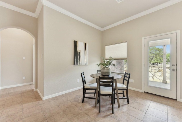 2812 Prosperity, Leander, TX 78641 - dining space with crown molding, arched walkways, baseboards, and light tile patterned floors