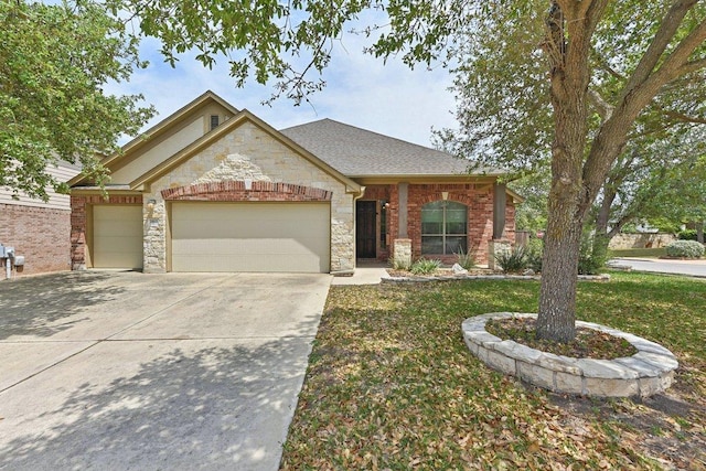 2812 Prosperity, Leander, TX 78641 - view of front of property featuring stone siding, an attached garage, driveway, and a front yard