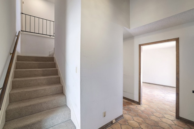 stairway featuring baseboards