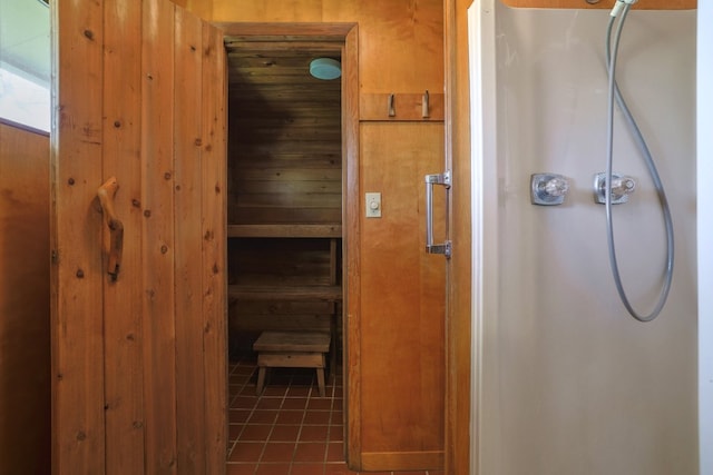 bathroom with tile patterned flooring, a shower, and a sauna