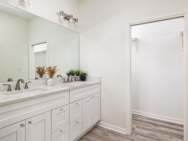 1401 W 7th St, Taylor, TX 76574 - full bathroom featuring double vanity and wood finished floors