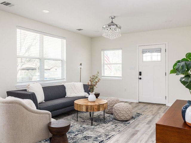 1401 W 7th St, Taylor, TX 76574 - living room with light wood-type flooring, a chandelier, and recessed lighting