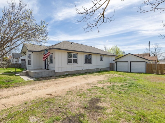 1401 W 7th St, Taylor, TX 76574 - back of property featuring dirt driveway, a detached garage, an outdoor structure, crawl space, and roof with shingles