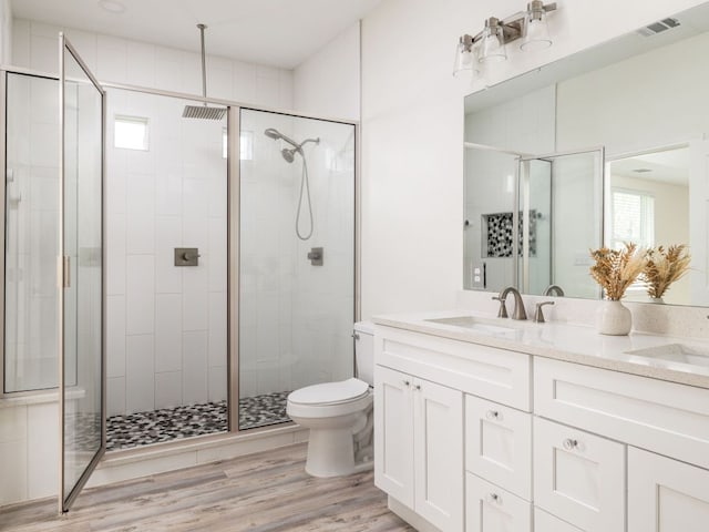 1401 W 7th St, Taylor, TX 76574 - full bath with a stall shower, double vanity, and wood finished floors