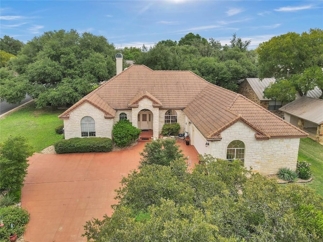 201 Lasso, Horseshoe Bay, TX 78657 - french country home featuring stone siding, a tile roof, and a front lawn