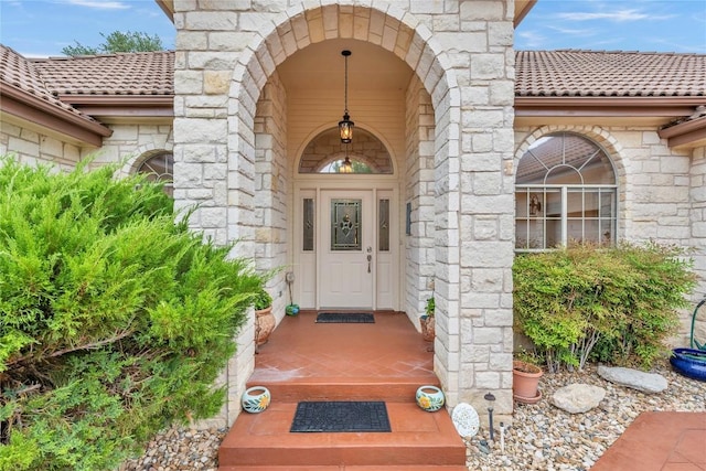 201 Lasso, Horseshoe Bay, TX 78657 - view of exterior entry with stone siding and a tiled roof