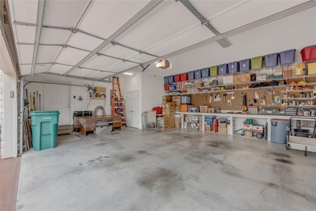 201 Lasso, Horseshoe Bay, TX 78657 - garage featuring a garage door opener and a workshop area