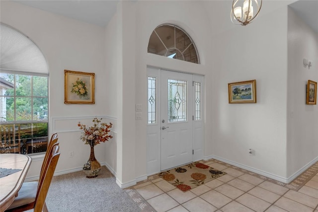 201 Lasso, Horseshoe Bay, TX 78657 - entrance foyer with a chandelier, light tile patterned flooring, and a towering ceiling