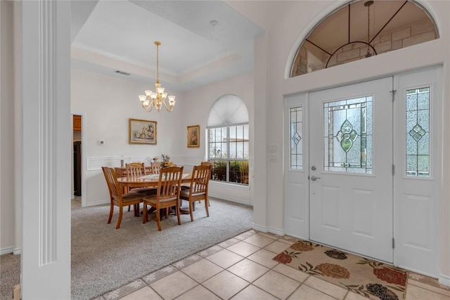 201 Lasso, Horseshoe Bay, TX 78657 - foyer entrance featuring a chandelier, light colored carpet, a tray ceiling, and light tile patterned floors