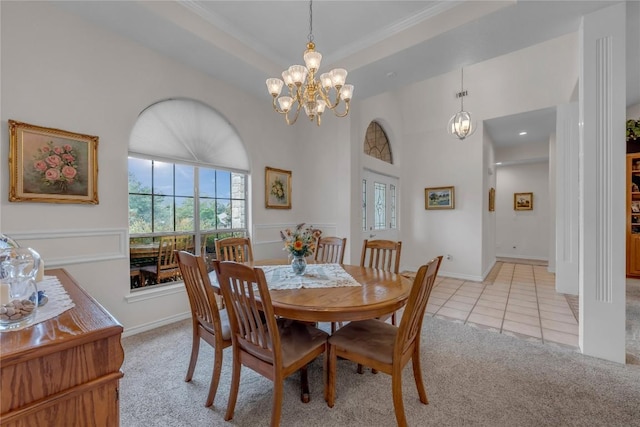 201 Lasso, Horseshoe Bay, TX 78657 - dining area featuring a chandelier, light colored carpet, light tile patterned flooring, a towering ceiling, and ornamental molding