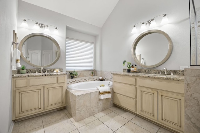 14320 Senia Bnd, Austin, TX 78738 - full bathroom with tile patterned flooring, two vanities, a sink, a garden tub, and lofted ceiling